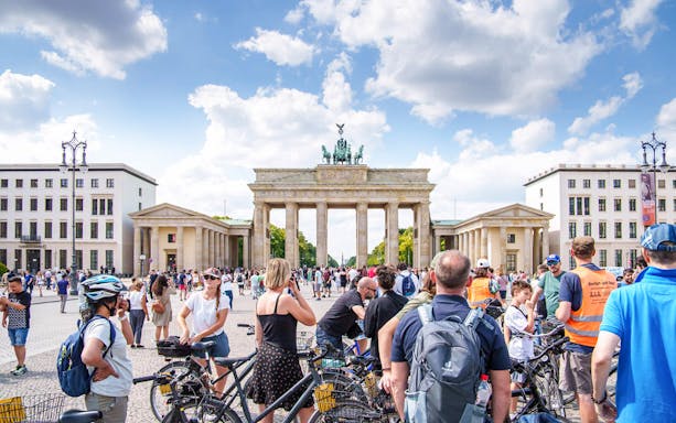 Cyclists gather near Berlin's Brandenburg Gate during a guided bike tour.