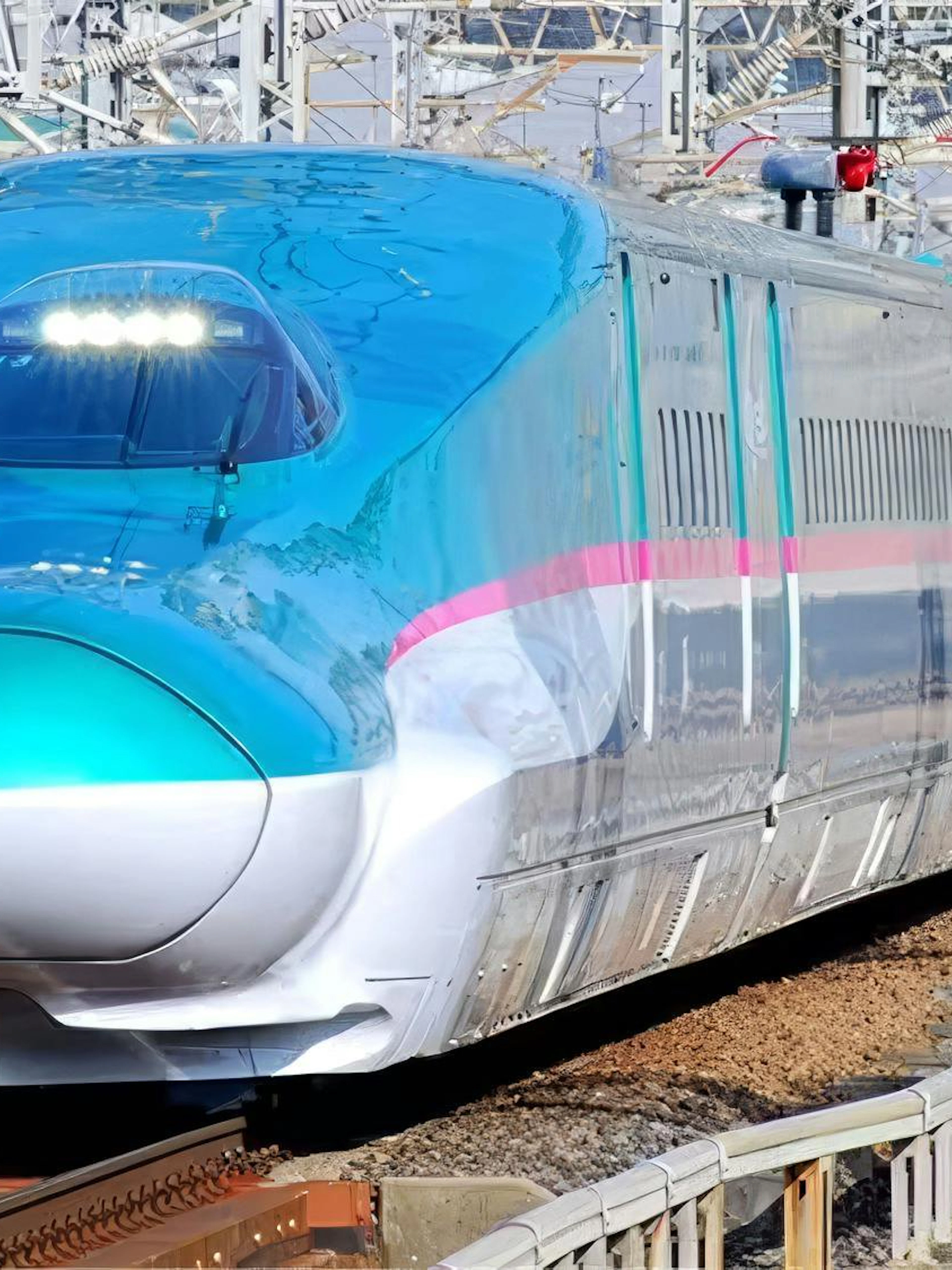 Japanese Shinkansen E5 Series bullet train on railway tracks.