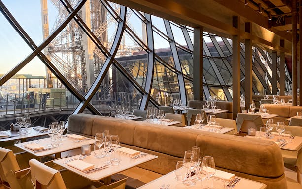 Dining tables set for Christmas lunch at Madame Brasserie inside the Eiffel Tower, Paris.