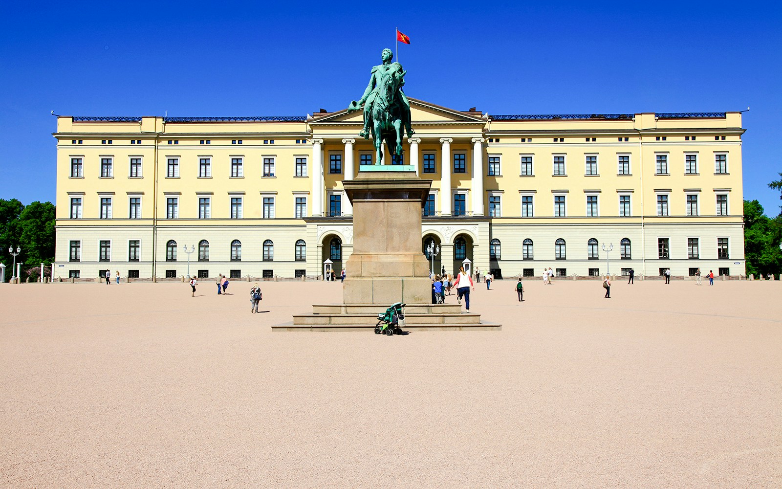Royal Palace in Oslo with statue and visitors in courtyard, Norway.