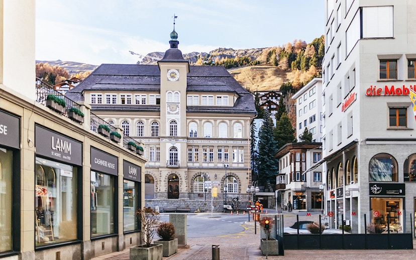 St. Moritz town center with historic building and mountain backdrop.