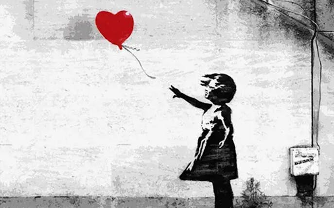 Child reaching for a red heart balloon, Theatre of Digital Art, The Little Prince Exhibition.