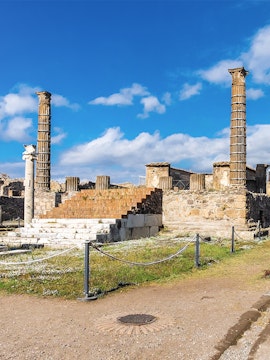 Ancient ruins with columns in Pompeii, Italy, viewed on a Naples to Pompeii tour.