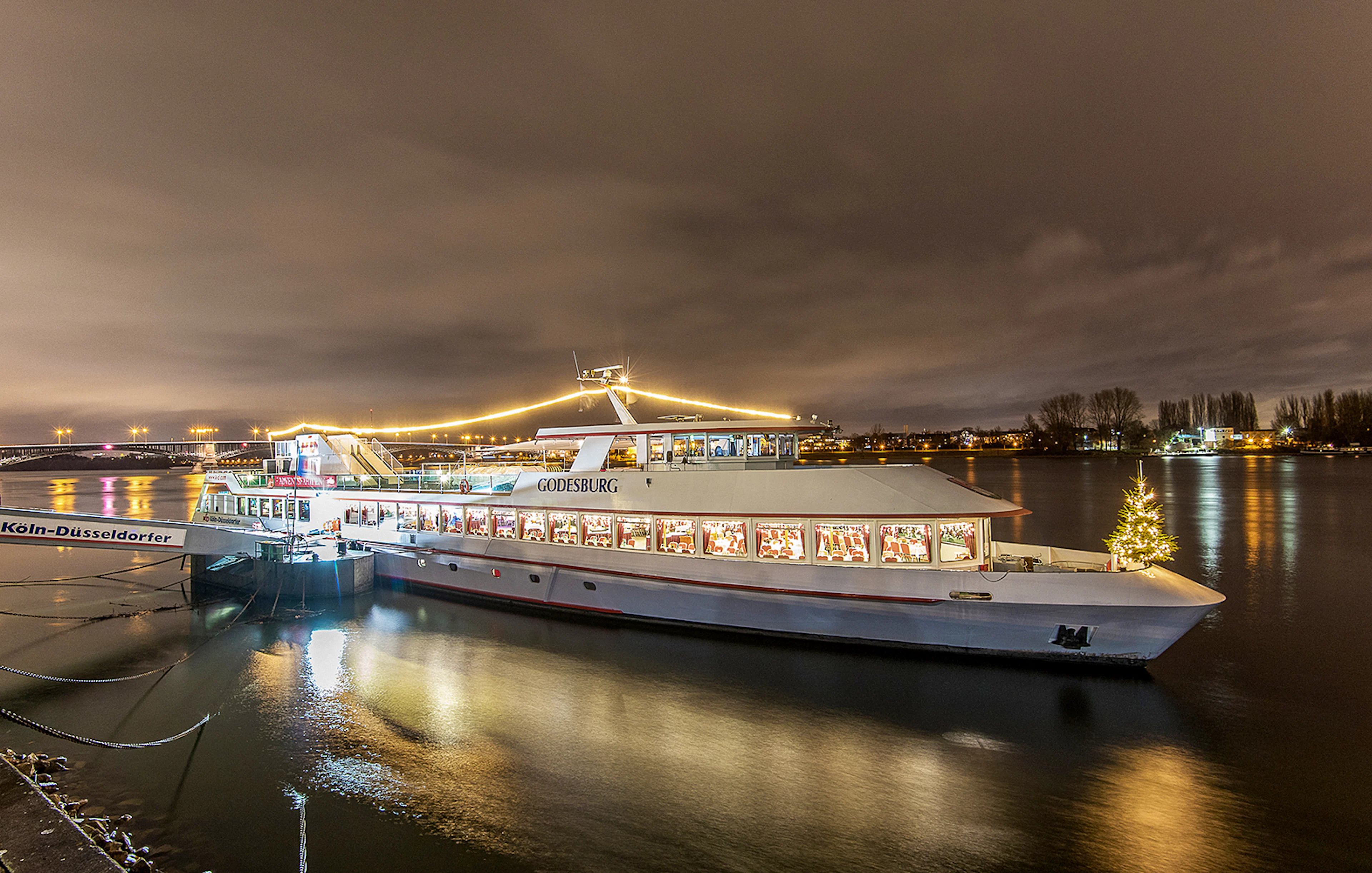 Cruise ship decorated with lights on the Rhine River during Advent in Mainz.