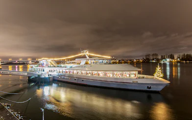 Cruise ship decorated with lights on the Rhine River during Advent in Mainz.