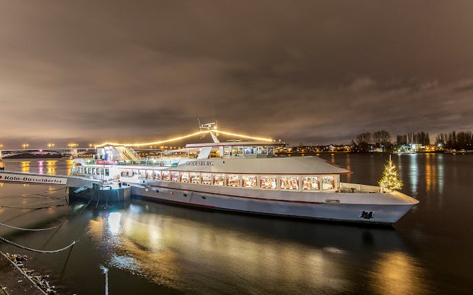 Cruise ship decorated with lights on the Rhine River during Advent in Mainz.