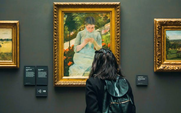 Visitor viewing "Young Girl in the Garden" by Mary Cassatt at Orsay Museum, Paris.