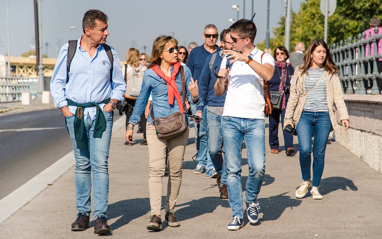 Visitors walking with a guide during the Grand City Tour near Parliament.