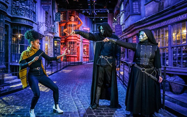 Wizards dueling in Diagon Alley during Dark Arts Halloween event at Harry Potter London tour.