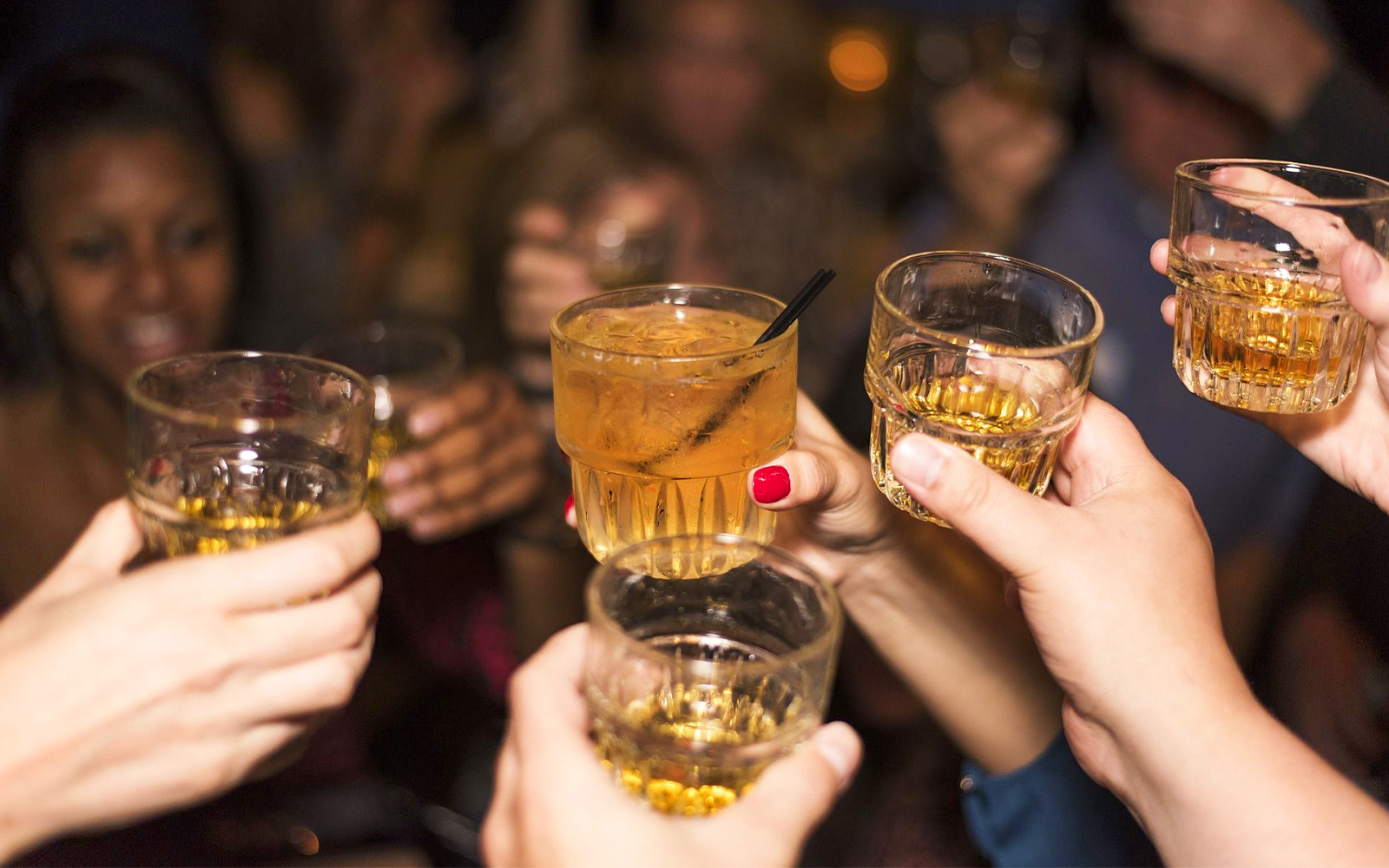 Guests toasting drinks during Statue of Liberty Ellis Island Sunset Cruise bar experience.