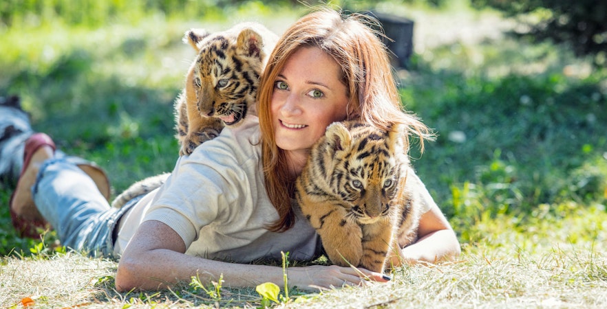 Tiger cub with a woman at Tiger Park Phuket