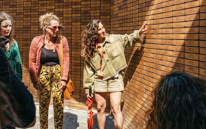 Visitors examining engraved bricks at the Dutch Holocaust Memorial of Names.
