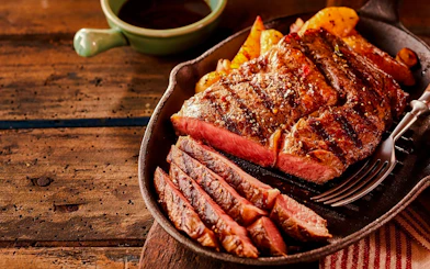 Grilled steak slices on a skillet at a Brazilian steakhouse in Rio de Janeiro.
