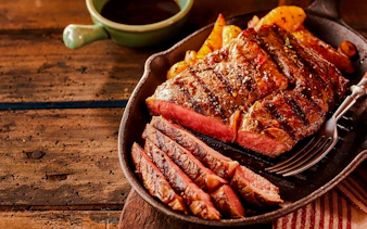 Grilled steak slices on a skillet at a Brazilian steakhouse in Rio de Janeiro.