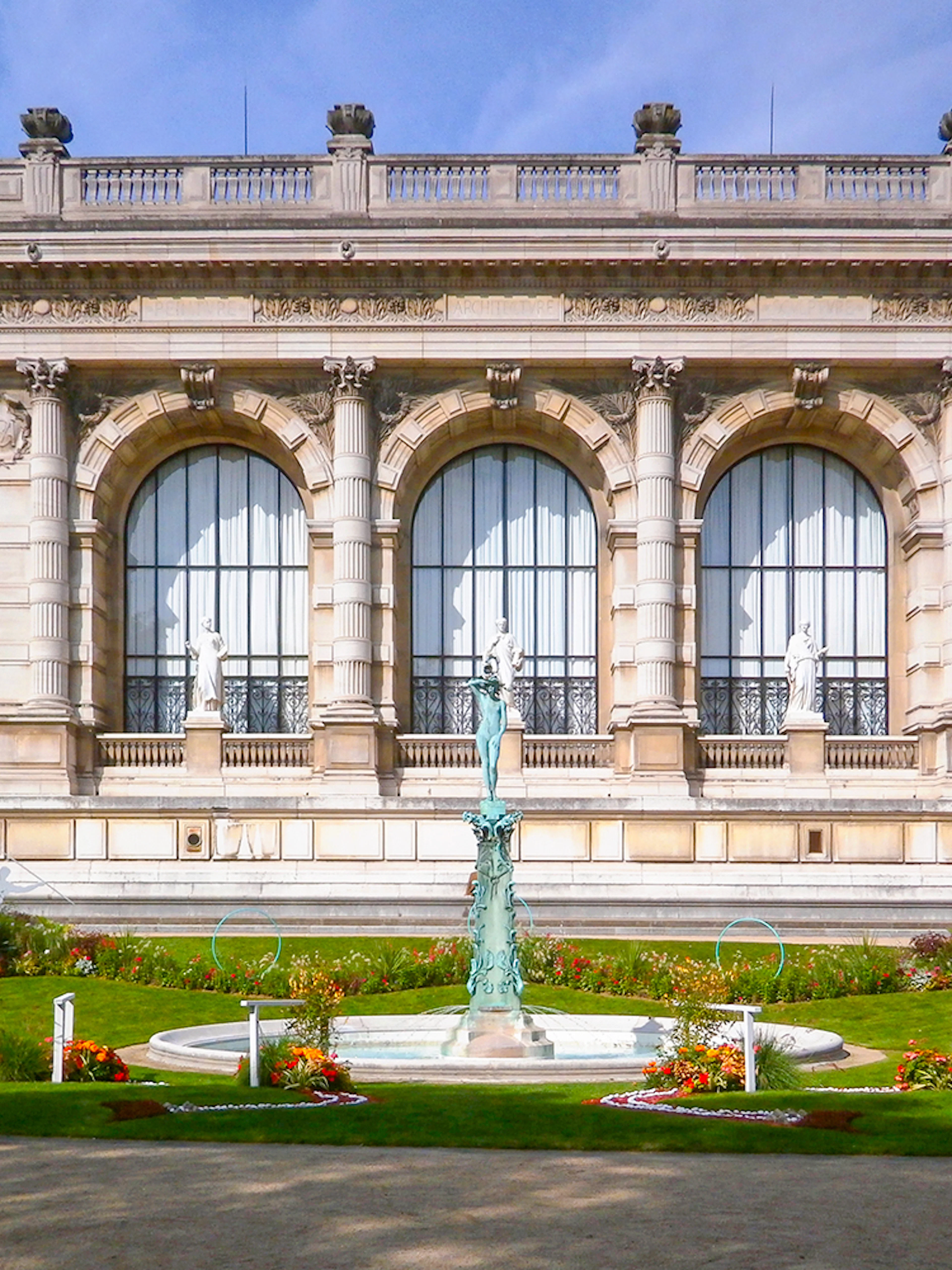 Palais Galliera exterior with garden and fountain in Paris, France.