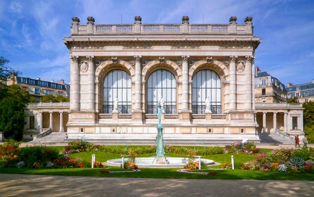 Palais Galliera exterior with garden and fountain in Paris, France.