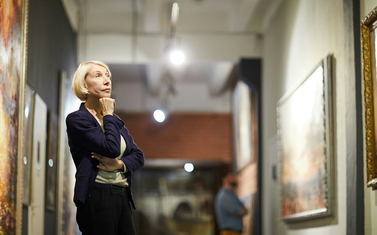 Person observing artwork in a gallery setting.