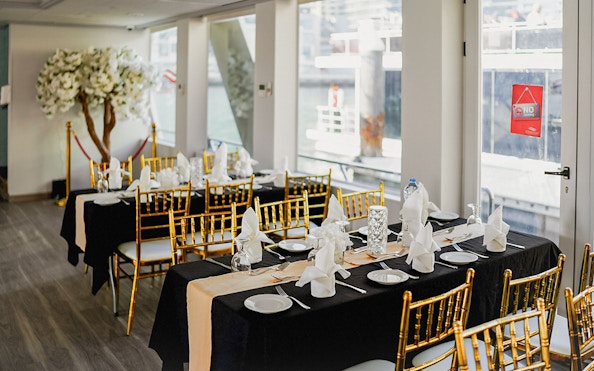 Elegant dining setup on Dubai Marina sunset cruise with buffet dinner.