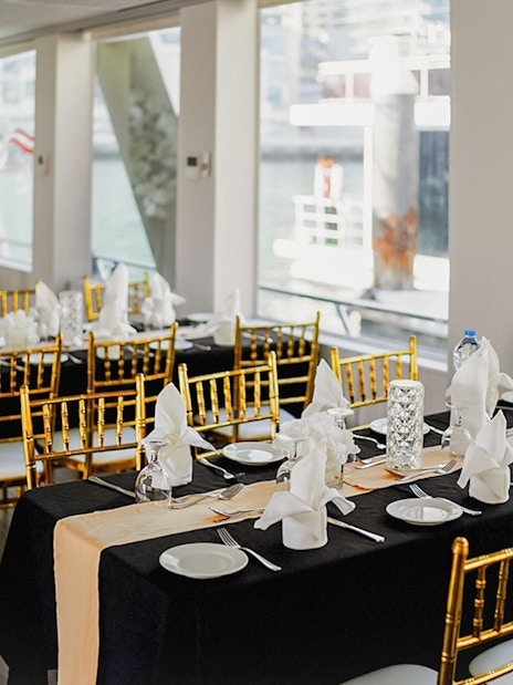 Elegant dining setup on Dubai Marina sunset cruise with buffet dinner.
