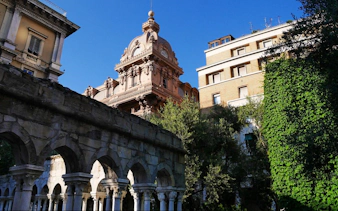 Historic architecture and arches in Genoa, Italy, featured in a self-guided city exploration game.