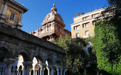 Historic architecture and arches in Genoa, Italy, featured in a self-guided city exploration game.