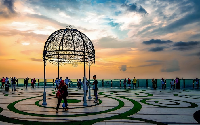 Visitors enjoying sunset views from The Shore Sky Tower observation deck.