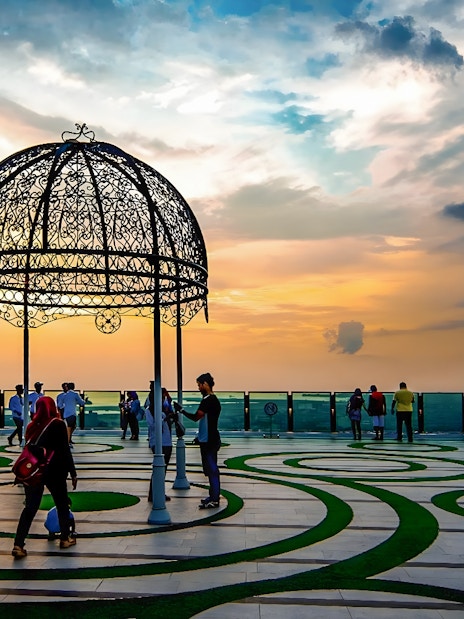 Visitors enjoying sunset views from The Shore Sky Tower observation deck.