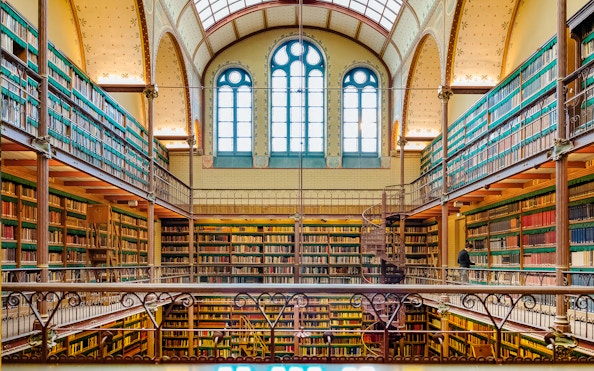Rijksmuseum library interior with spiral staircase and bookshelves, Amsterdam.