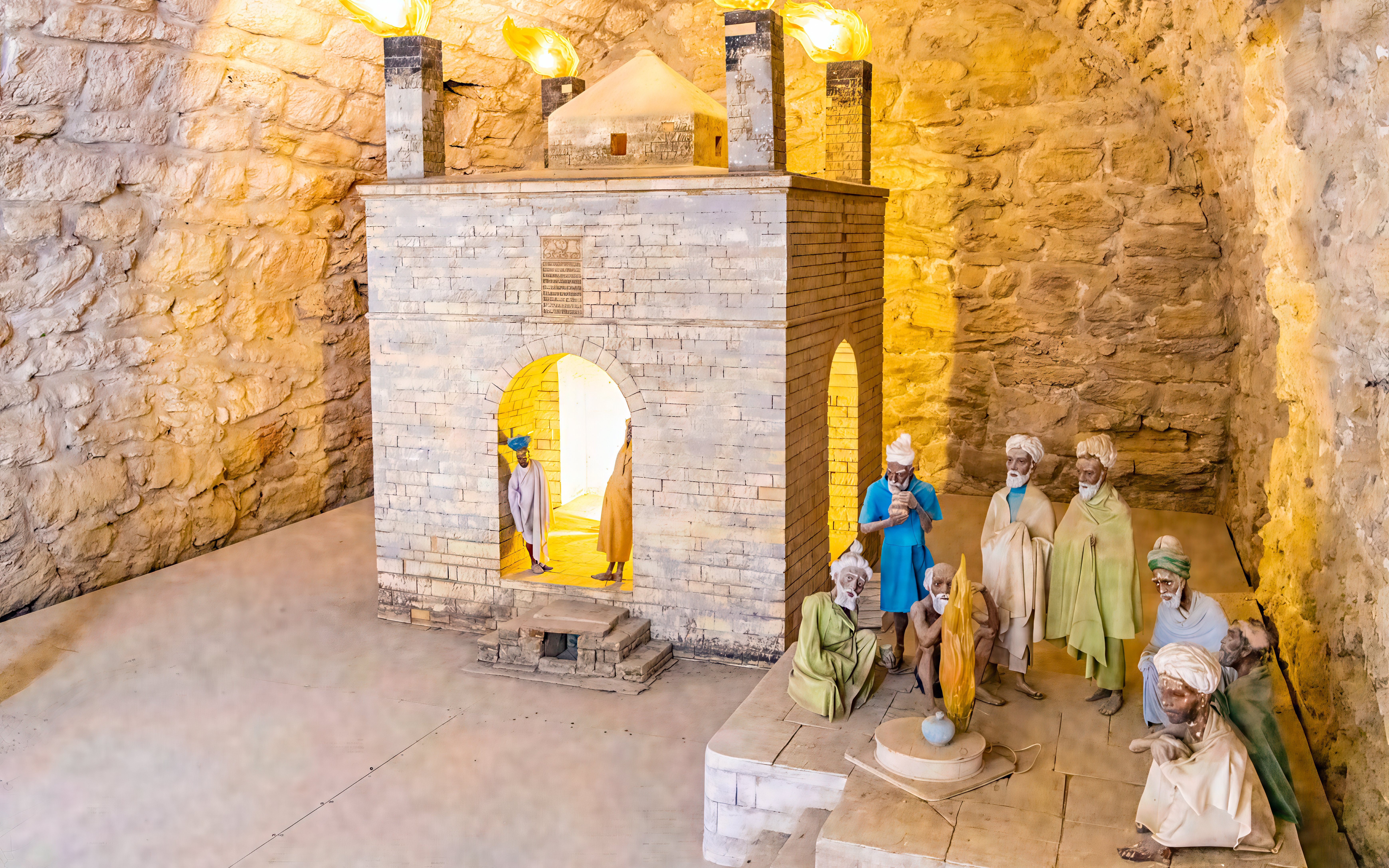 Teshgah Fire Temple interior with stone structure and figures in Azerbaijan.