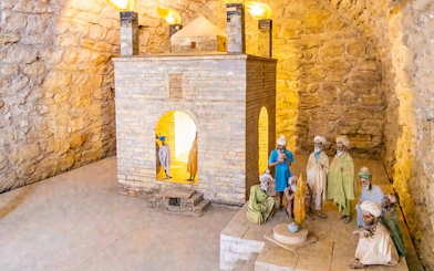 Teshgah Fire Temple interior with stone structure and figures in Azerbaijan.
