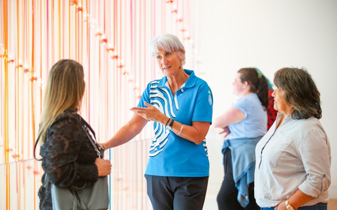 Guide explaining exhibit to visitors at Museum of NZ Te Papa Tongarewa.