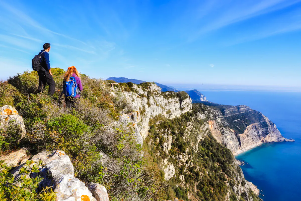 Hikers overlooking cliffs and ocean on Arrábida Jeep Tour near Lisbon.