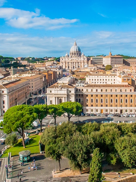 View of Vatican City from Passetto di Borgo, featuring St. Peter's Basilica and surrounding architecture.