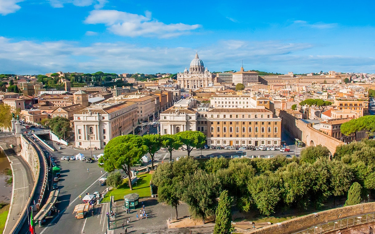 View of Vatican City from Passetto di Borgo, featuring St. Peter's Basilica and surrounding architecture.
