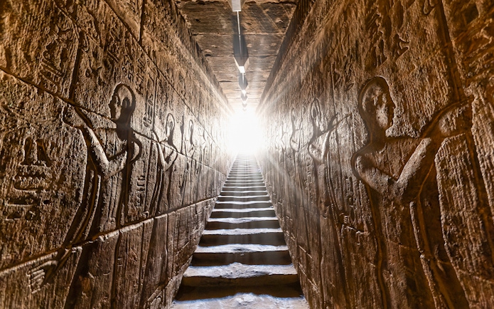 Hieroglyphic carvings on passage walls inside Temple of Horus, Edfu, Egypt.