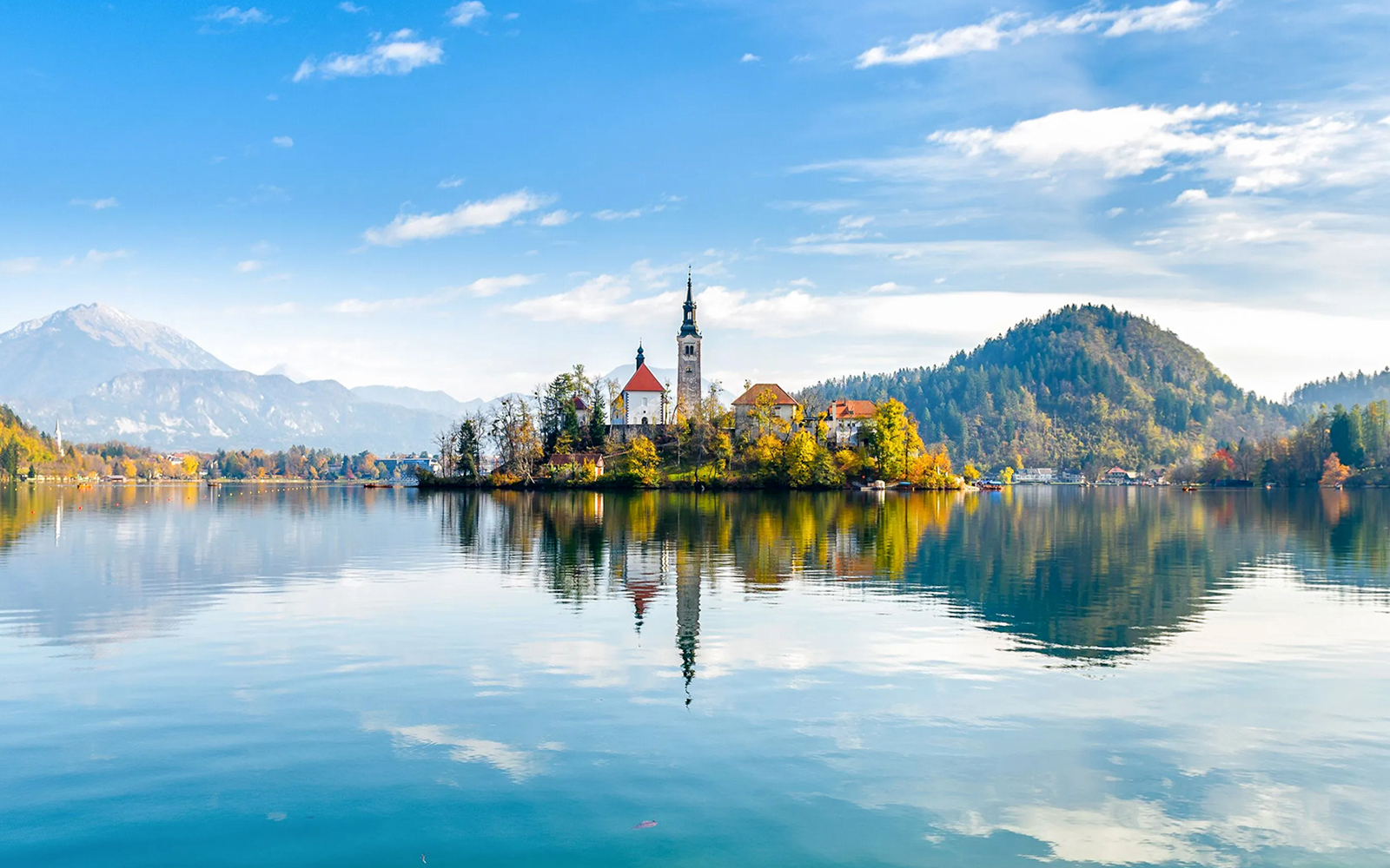 Bled Lake with island church and surrounding mountains in Slovenia.
