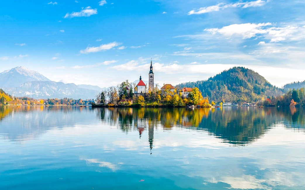 Bled Lake with island church and surrounding mountains in Slovenia.