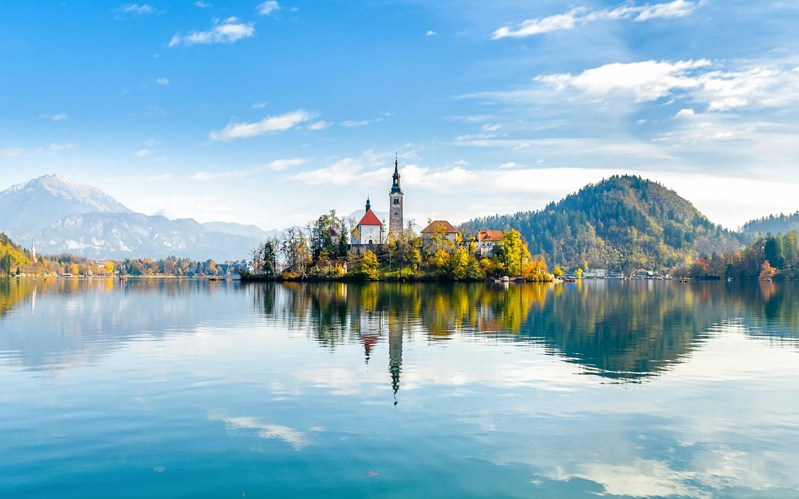 Bled Lake with island church and surrounding mountains in Slovenia.