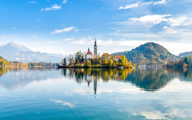 Bled Lake with island church and surrounding mountains in Slovenia.