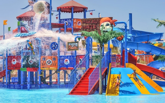 Pirate-themed slides at Makadi Water World, Hurghada with children playing.