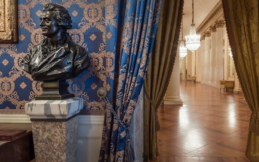 Bust and ornate hallway inside La Scala Theatre and Museum, Milan.
