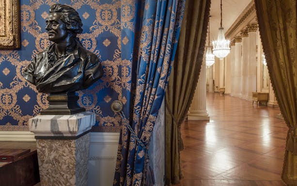 Bust and ornate hallway inside La Scala Theatre and Museum, Milan.