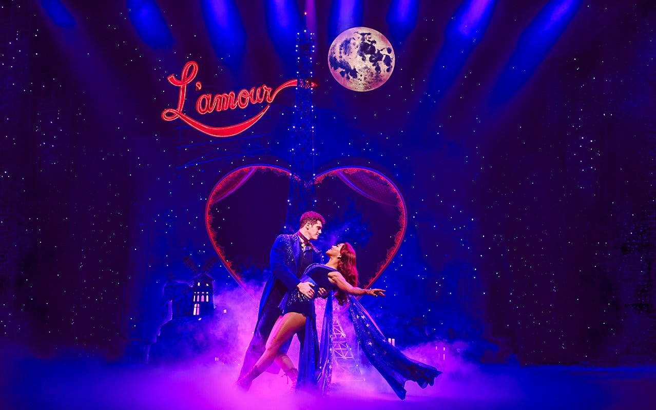 Stage performance of Come Alive Westend with dancers under a moonlit sky.