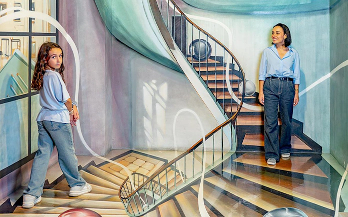 Visitors exploring optical illusion room at Big Fun Museum, Barcelona.