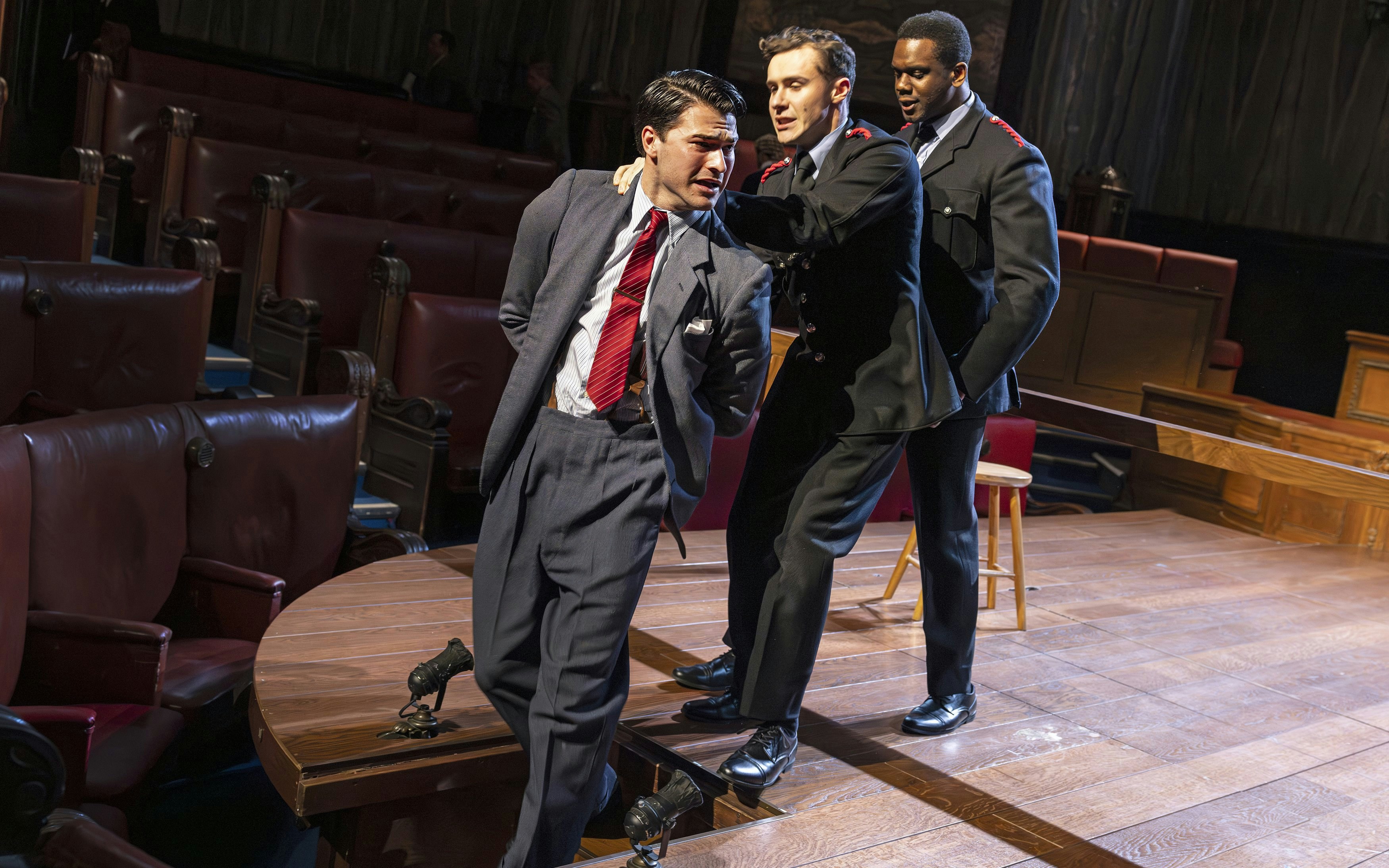Courtroom scene from "Witness for the Prosecution" performance with actors in dramatic pose.