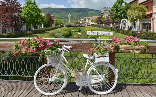 White bicycle with flowers on a bridge at Barberino Designer Outlet, Florence.