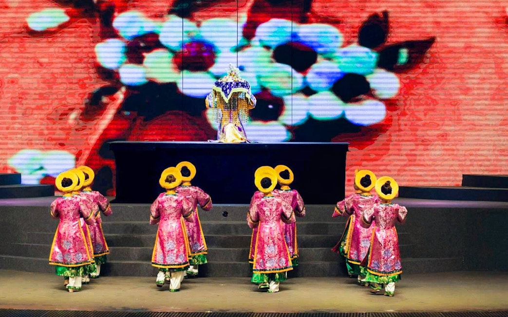 Performers in traditional costumes on stage at Charming Danang Show, Da Nang.