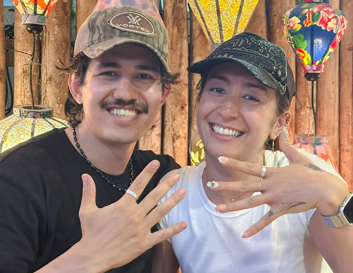Couple showcasing handmade rings at a jewelry workshop in Hoi An.