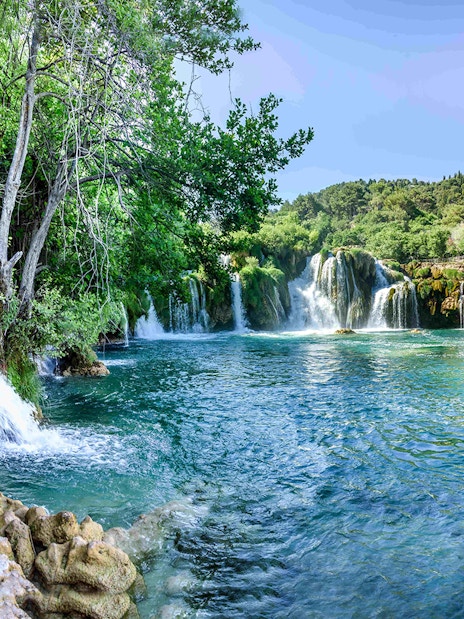 Waterfalls and lush greenery at Plitvice Lakes during a private day tour from Split.