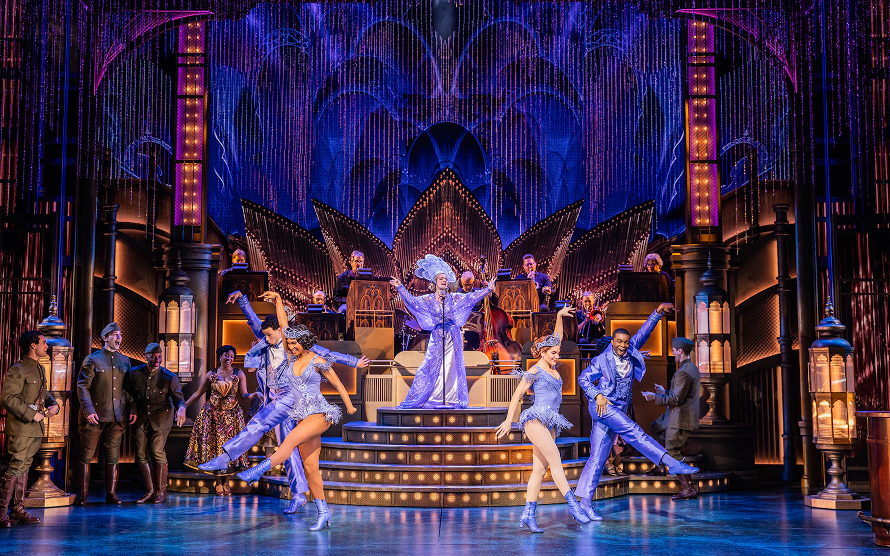 Stage performance of The Great Gatsby with dancers in 1920s attire and a jazz band.
